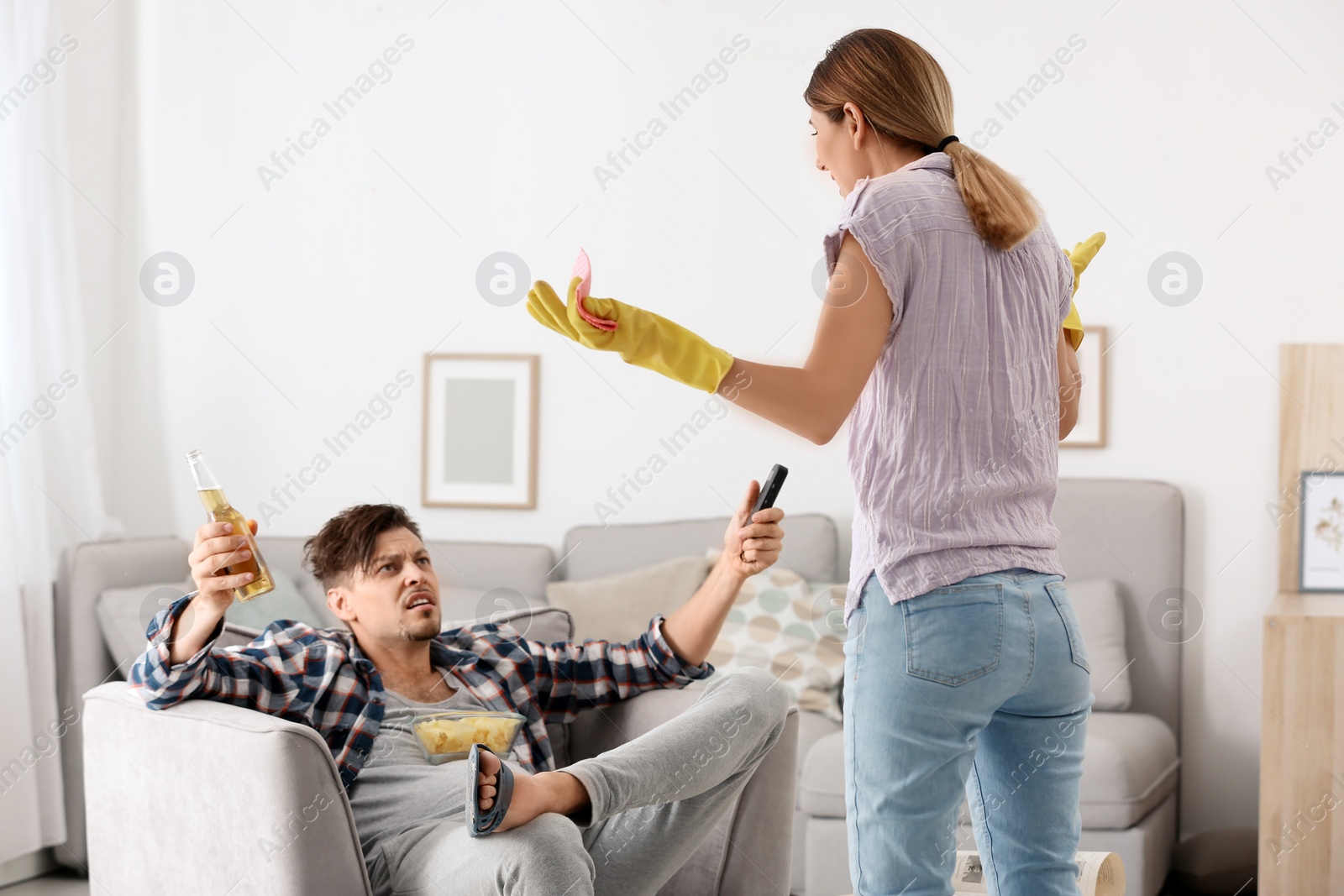 Photo of Lazy husband quarrelling with hardworking wife at home