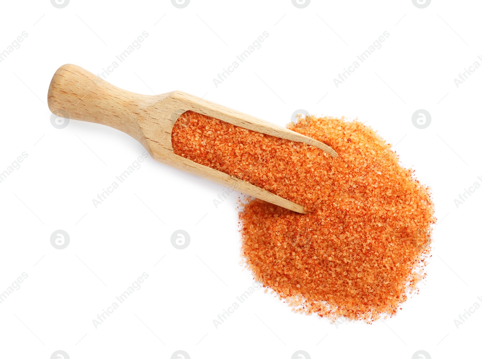 Photo of Wooden scoop with orange salt on white background, top view