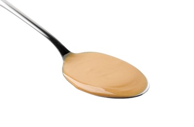 Photo of Spoon with tasty peanut butter isolated on white