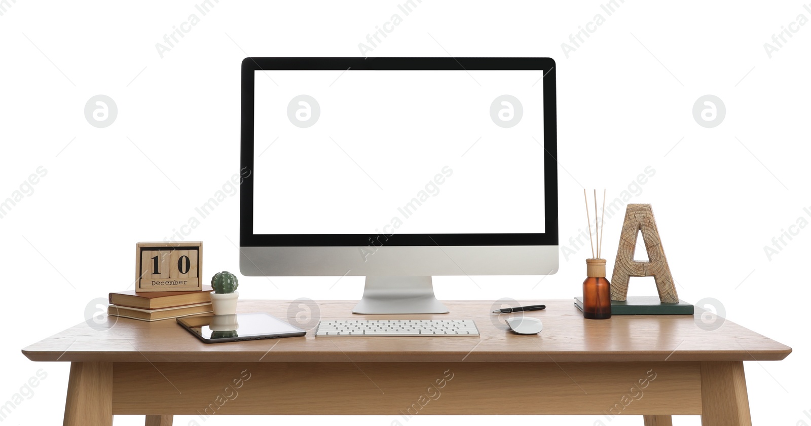 Photo of Wooden table with modern computer, decor and stationery on white background