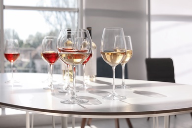 Glasses with delicious wine on table indoors