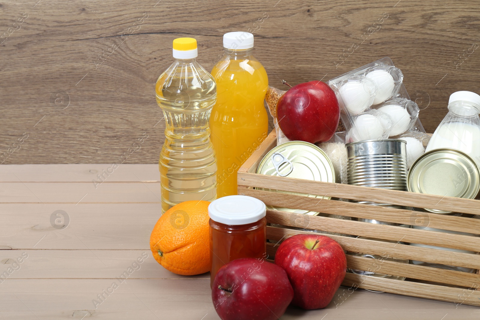 Photo of Different donation food on wooden table, space for text