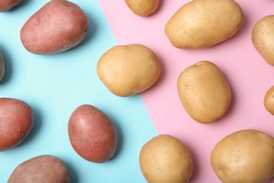 Flat lay composition with fresh organic potatoes on color background