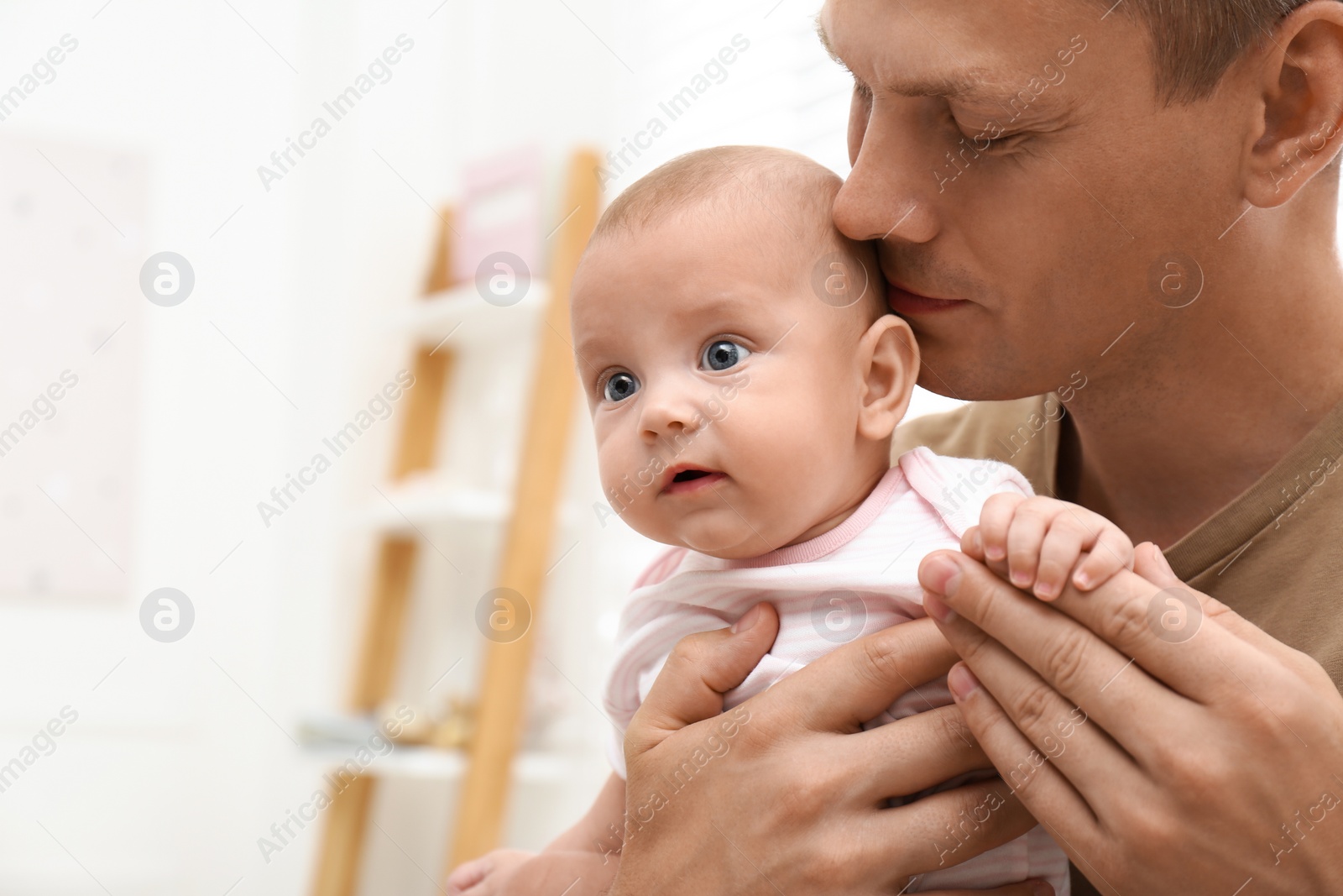 Photo of Happy father with his little baby at home. Space for text