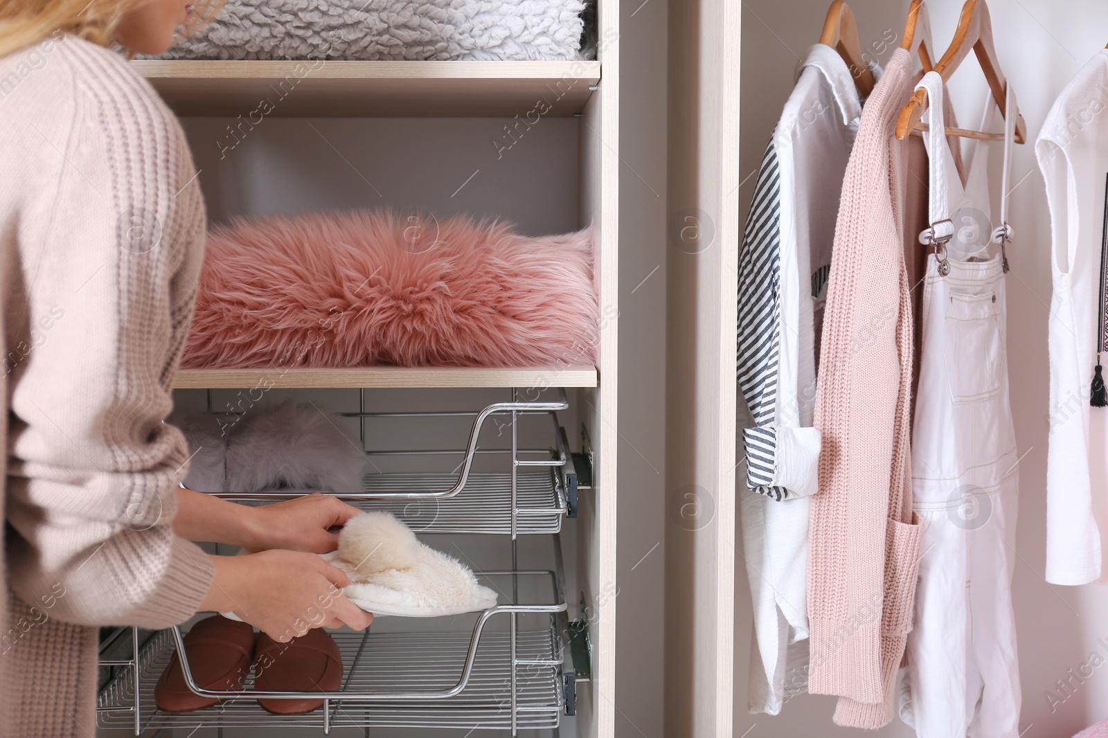 Photo of Woman taking slippers out of wardrobe drawer