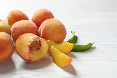 Photo of Fresh sweet peaches on wooden table, closeup