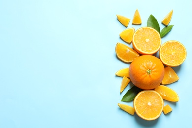 Flat lay composition with ripe oranges and space for text on color background