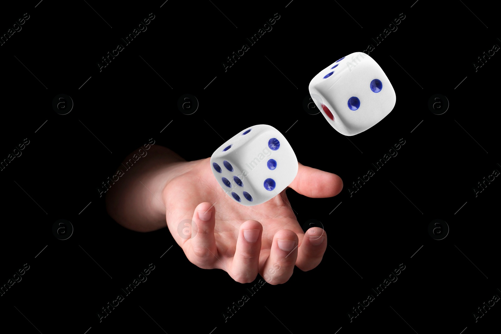 Image of Man throwing white dice on black background, closeup