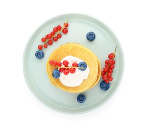 Photo of Tasty pancakes with natural yogurt, blueberries and red currants on white background, top view
