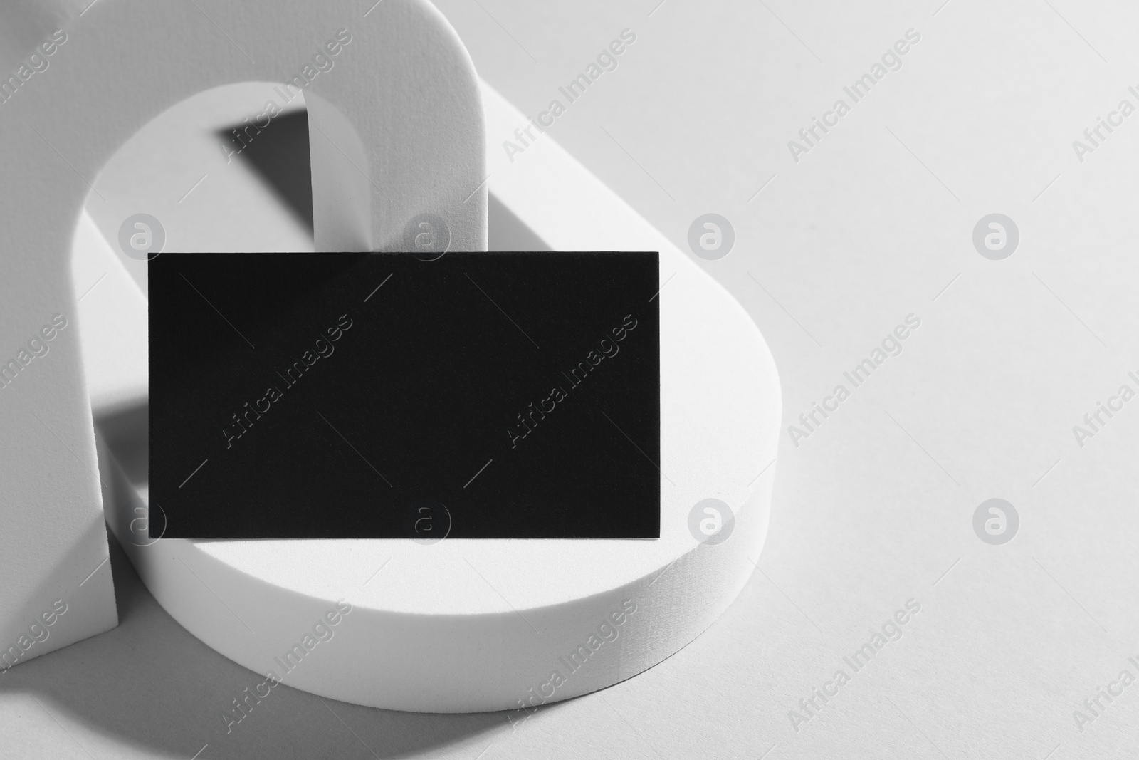 Photo of Empty black business card and decorative elements on white background. Mockup for design