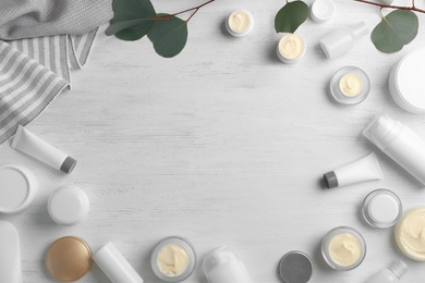 Photo of Flat lay composition with hand cream jars and space for text on wooden background