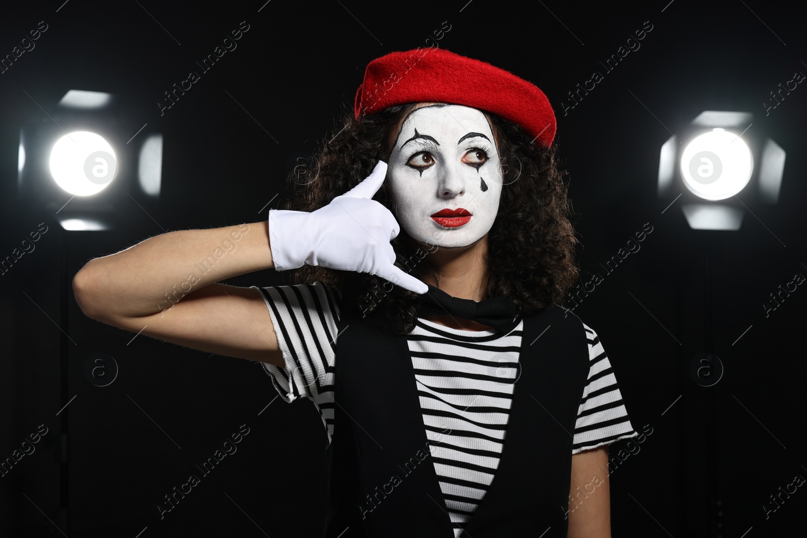 Photo of Young woman in mime costume performing on stage