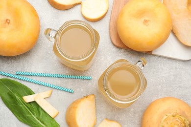 Photo of Freshly made turnip juice on light grey table, flat lay