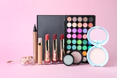 Different luxury decorative cosmetics on pink background