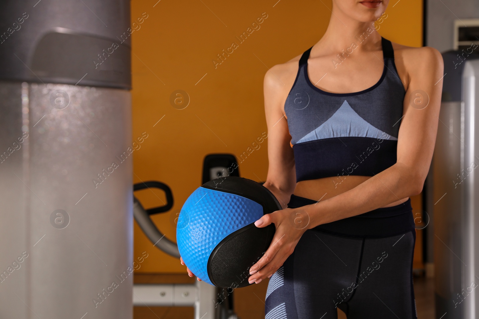 Photo of Woman with medicine ball in gym, closeup
