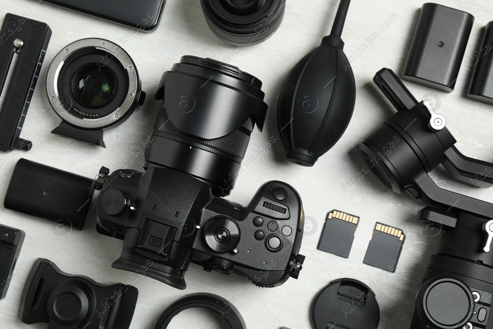 Photo of Flat lay composition with camera and video production equipment on light background