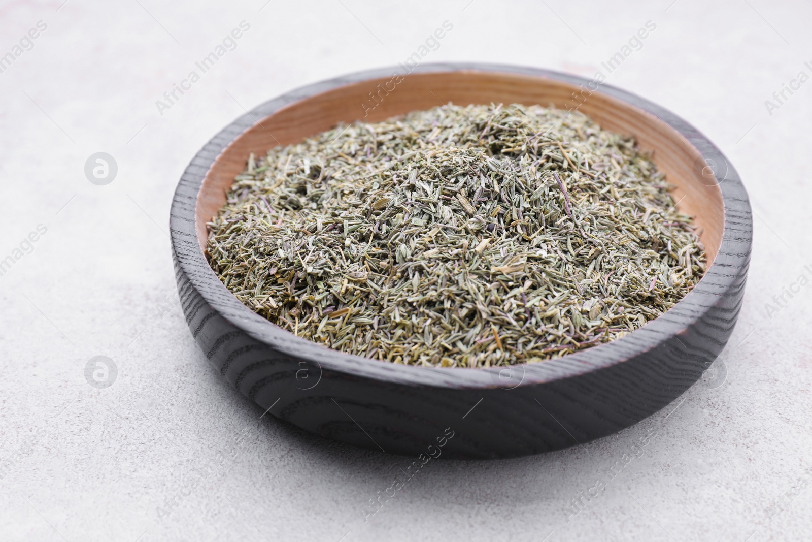 Photo of Plate with dried thyme on grey table, closeup