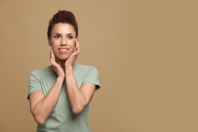 Photo of Portrait of beautiful young woman on light brown background. Space for text