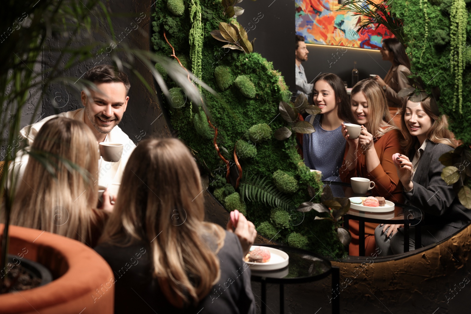 Photo of People with coffee spending time together in cafe