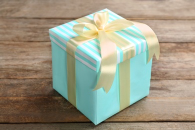Photo of Elegant gift box with bow on wooden background