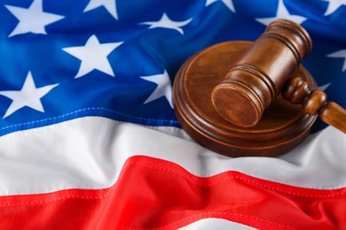 Photo of Judge's gavel on national American flag, closeup. Space for text