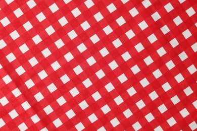 Red checkered tablecloth as background, top view