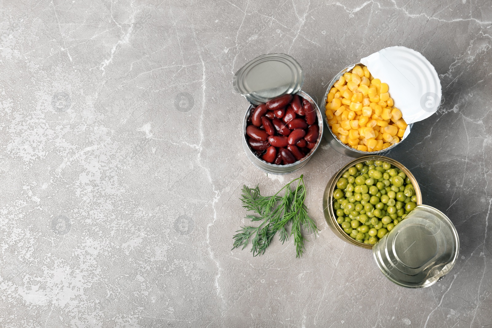 Photo of Flat lay composition with canned vegetables on grey background