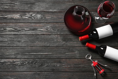 Photo of Glassware with red wine on wooden background, top view