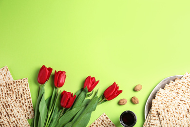 Photo of Flat lay composition with matzos on green background, space for text. Passover (Pesach) celebration