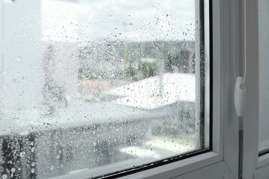 Window glass with water drops, closeup. Condensation