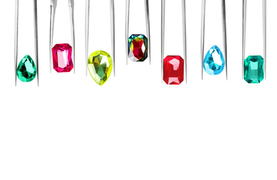 Image of Set of tweezers with different shiny gemstones on white background