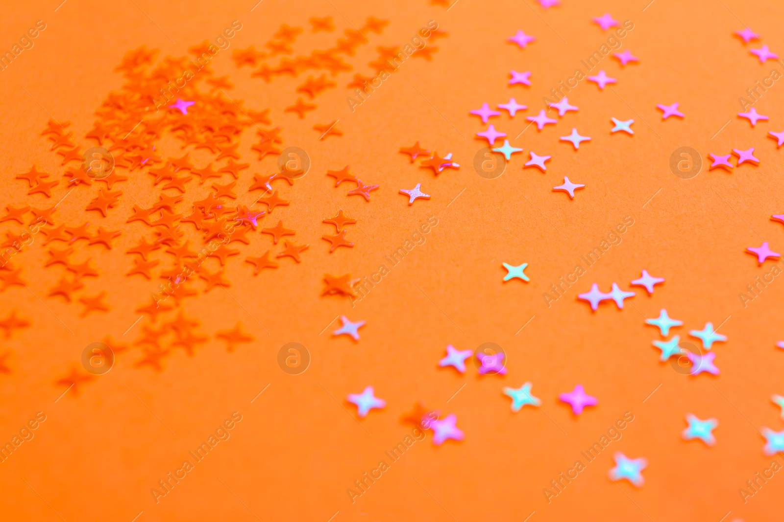 Photo of Shiny bright glitter on light pink background