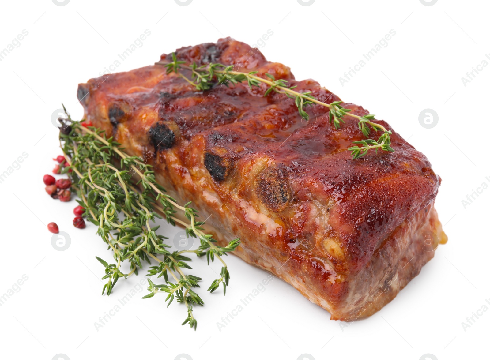 Photo of Tasty roasted pork ribs and thyme isolated on white