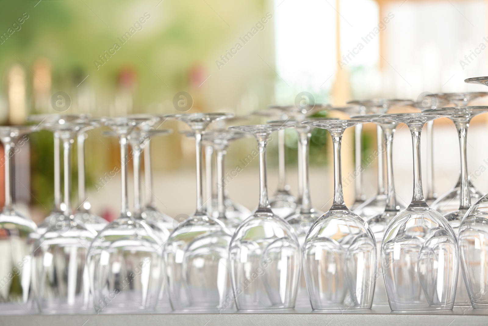 Photo of Empty glasses on table against blurred background