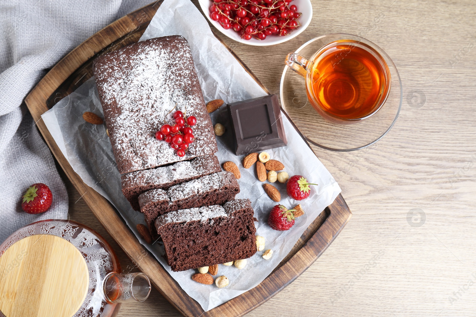 Photo of Tasty chocolate sponge cake served on wooden table, flat lay. Space for text