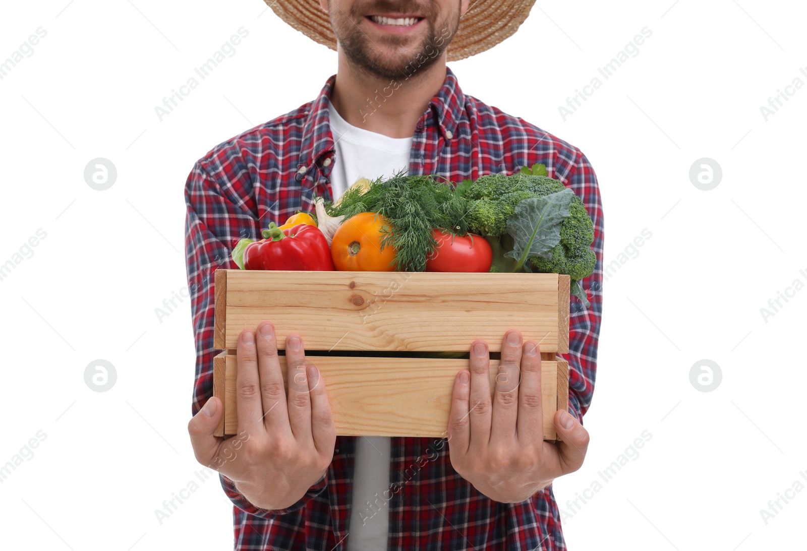 Photo of Harvesting season. Happy farmer holding wooden crate with vegetables on white background, closeup