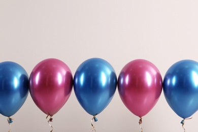 Color balloons with ribbons on white background. Space for text