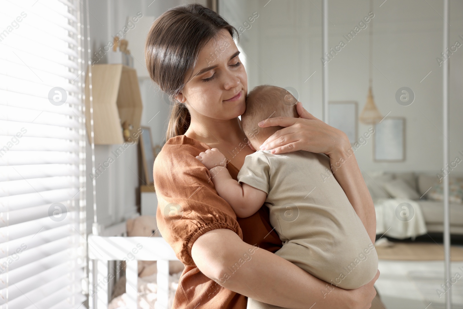 Photo of Happy young mother with her baby at home