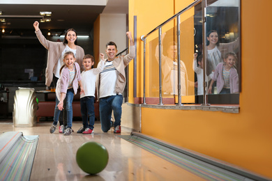 Happy family spending time together in bowling club