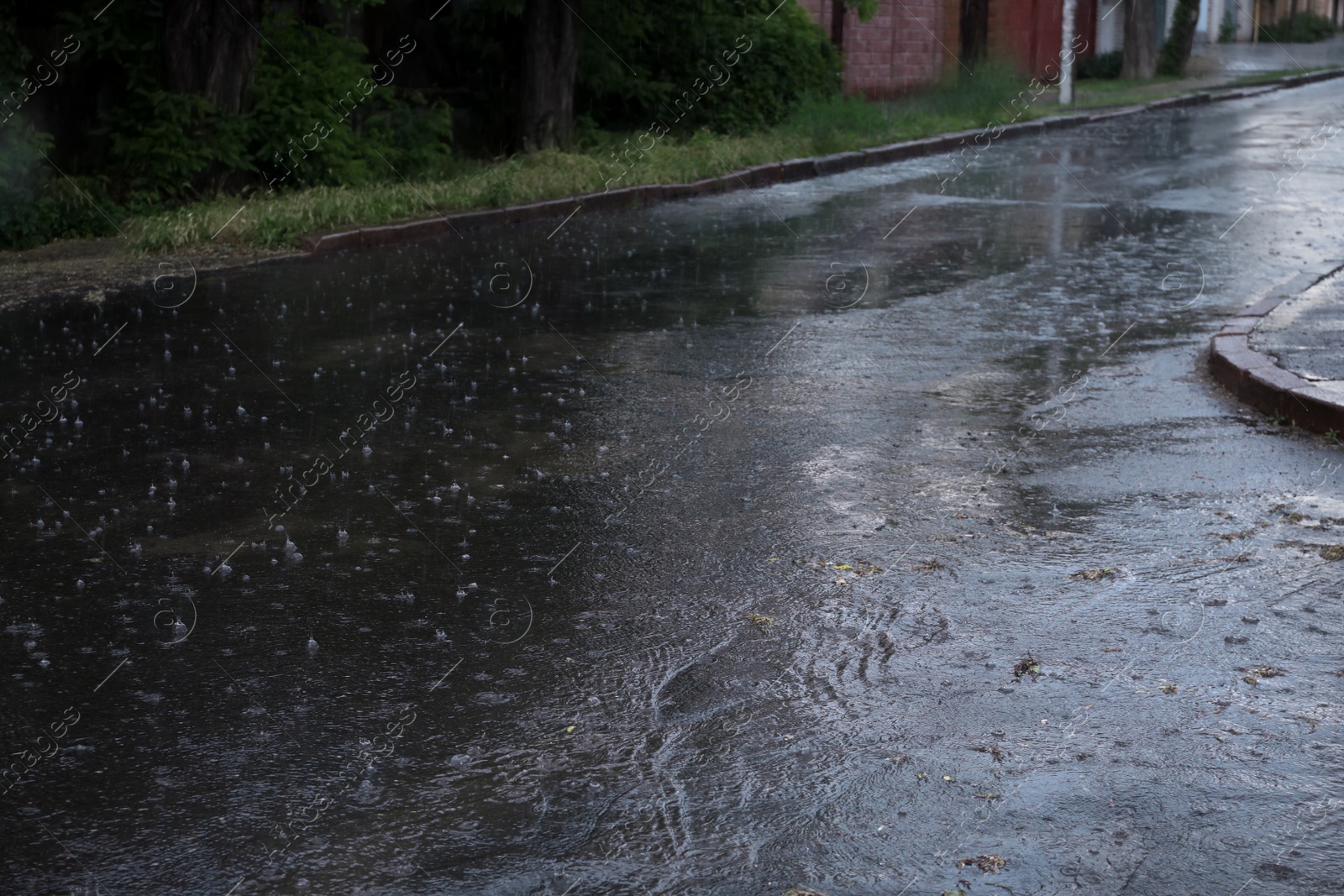 Photo of View of heavy pouring rain on city street