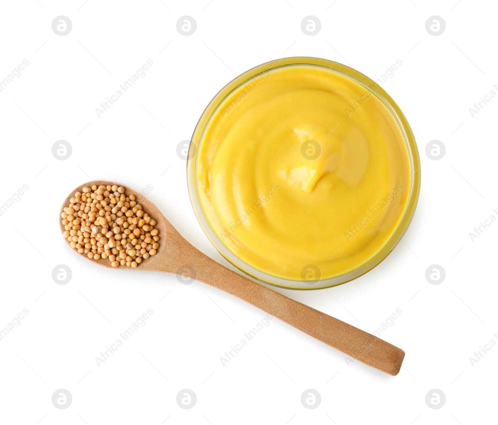 Photo of Bowl of delicious mustard and spoon with seeds on white background, top view