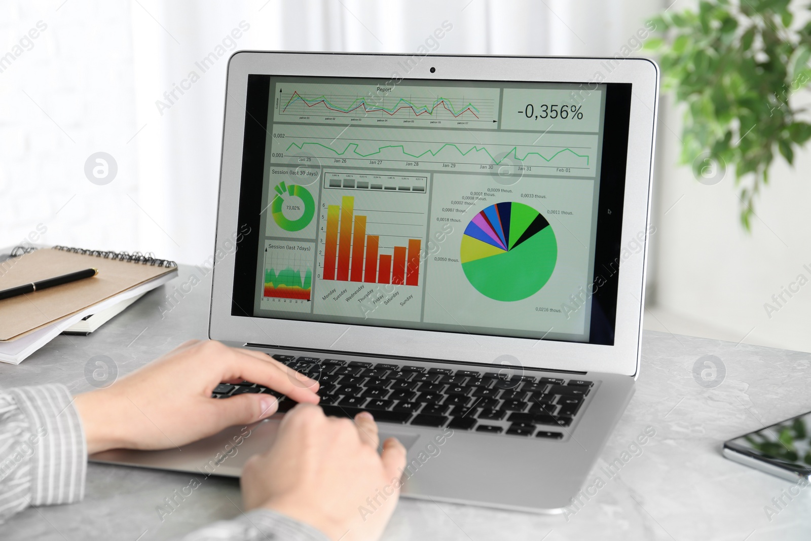 Photo of Woman using laptop at desk in office, closeup