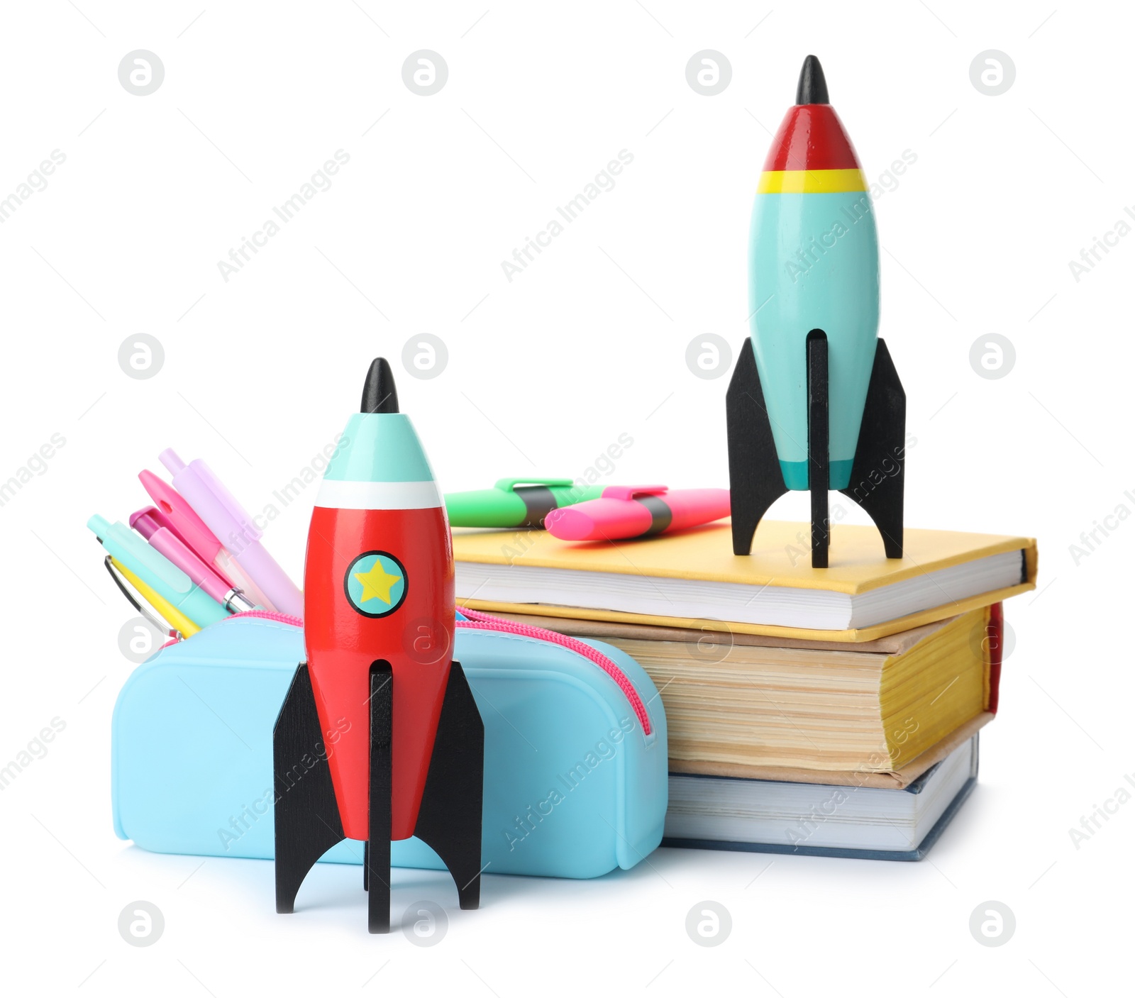 Photo of Bright toy rockets and school supplies on white background