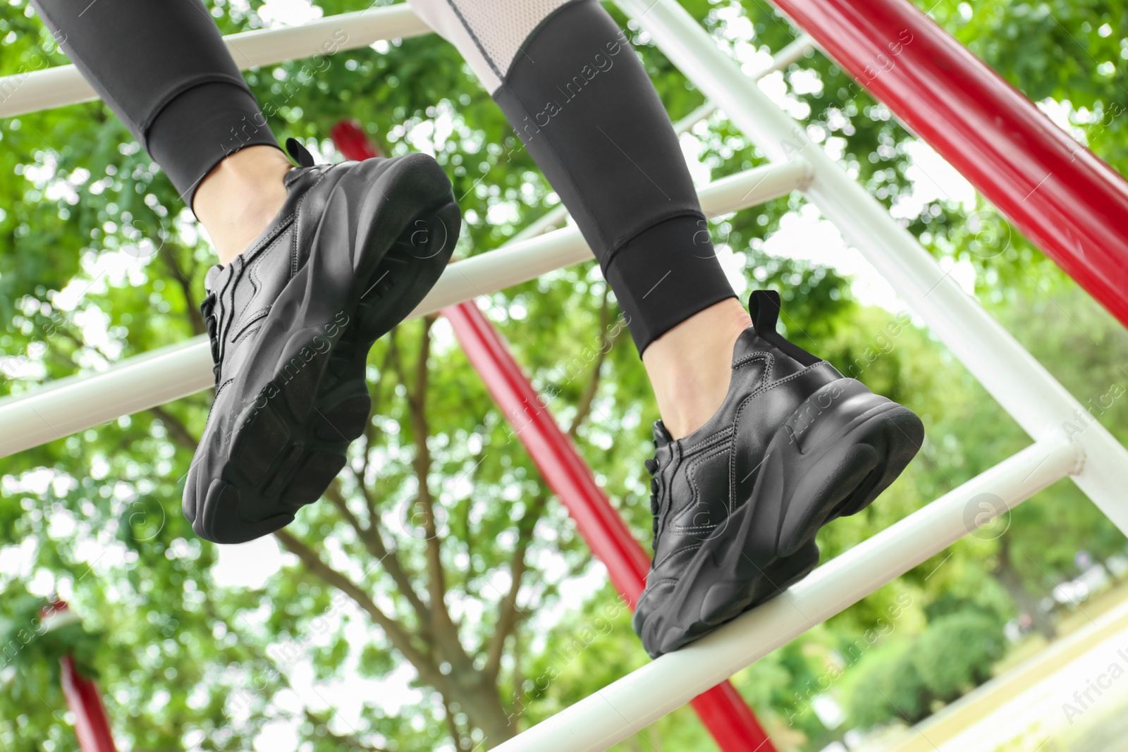 Photo of Woman in comfortable stylish shoes training outdoors, closeup