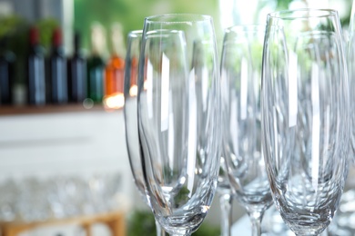 Photo of Empty glasses against blurred background, closeup view