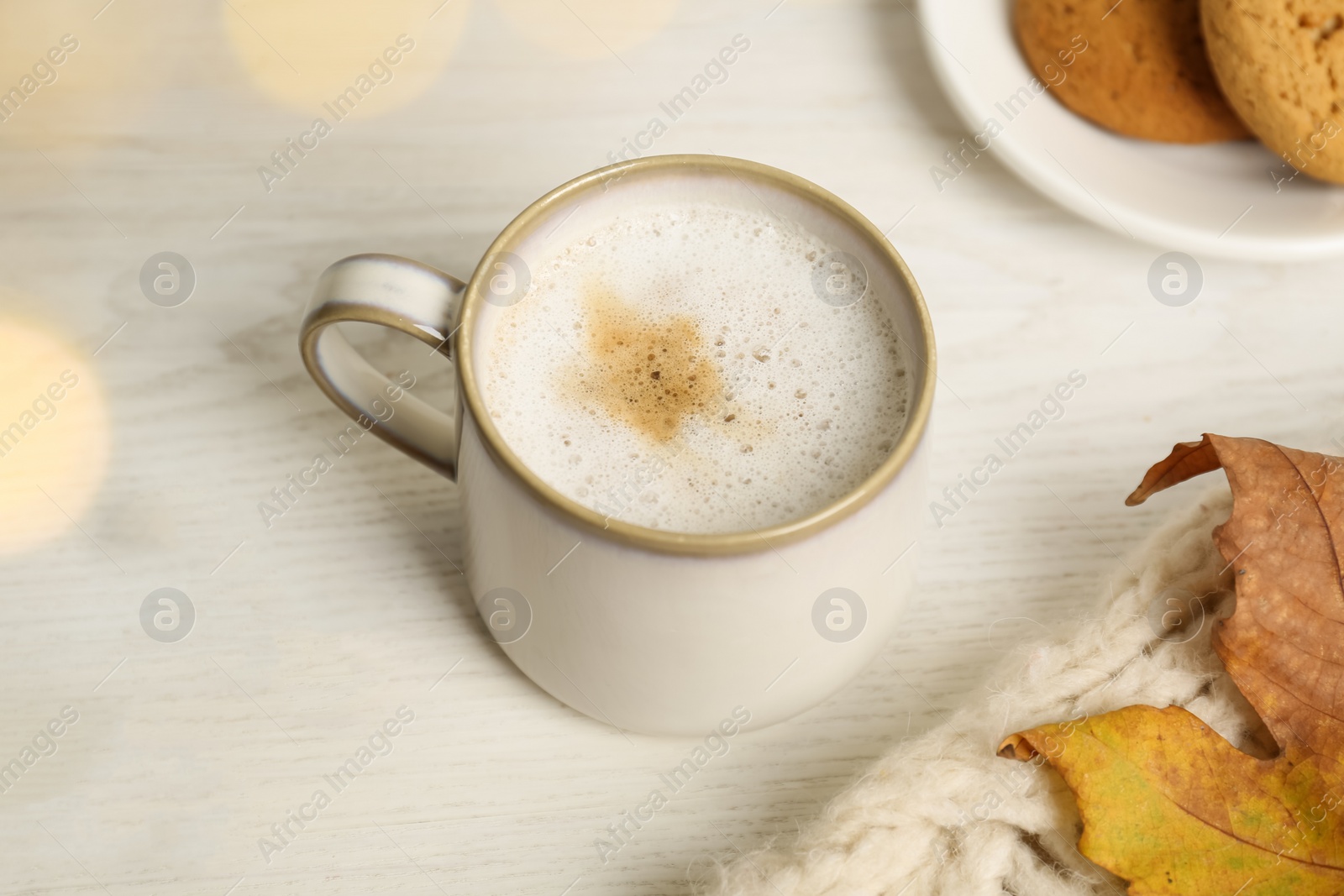 Photo of Cup of hot coffee on white wooden table