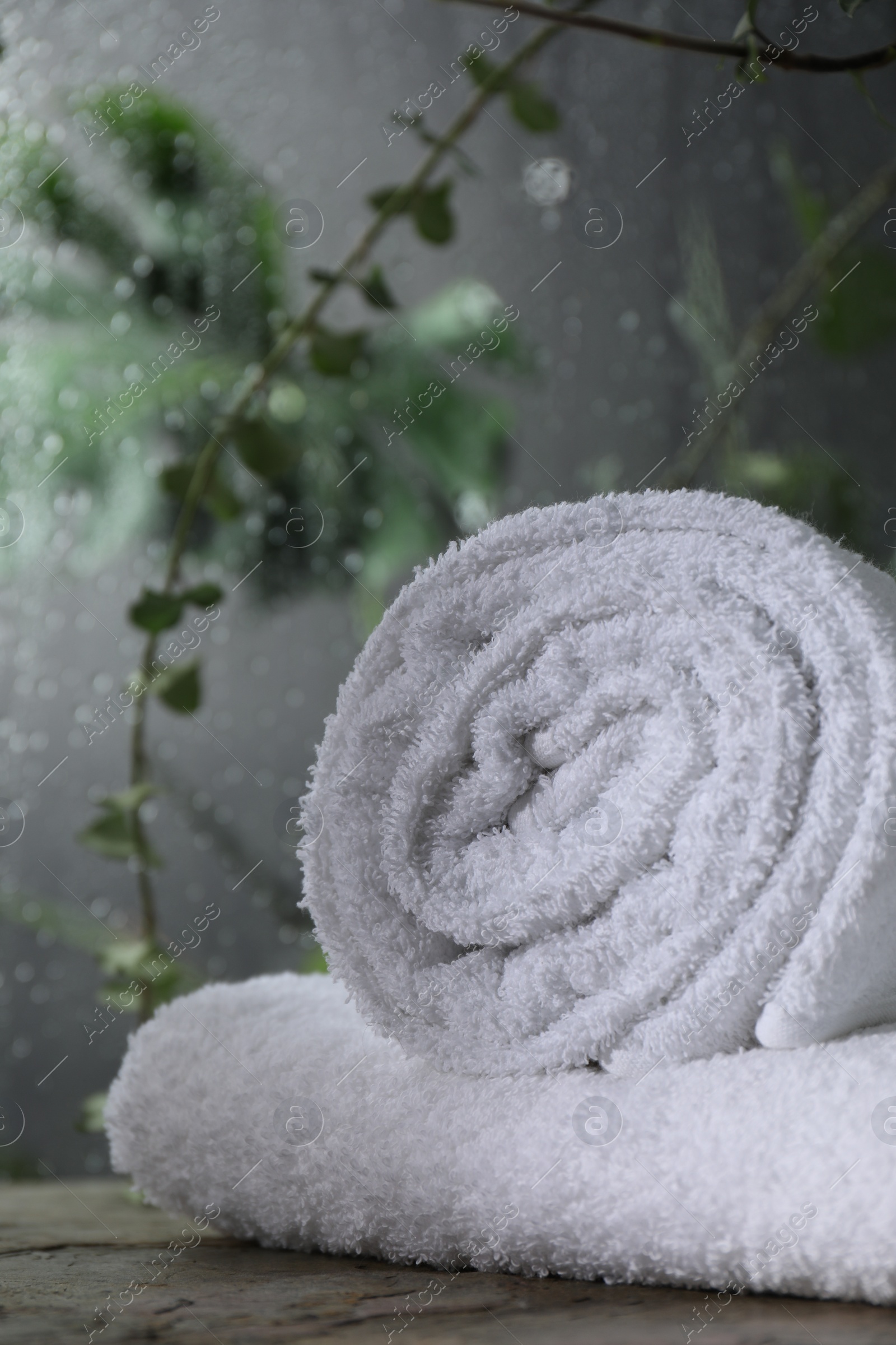 Photo of White terry towels on table in bathroom