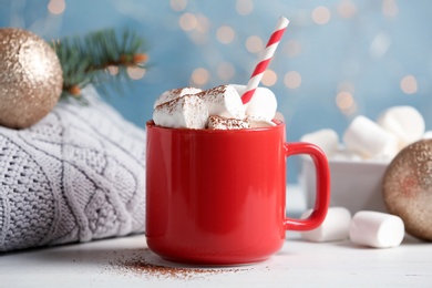 Composition with hot cocoa drink and marshmallows on table