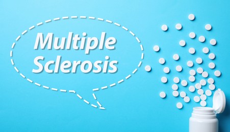 Multiple sclerosis treatment. Bottle with pills on light blue background, flat lay