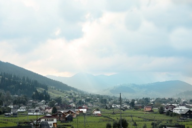 Photo of Beautiful landscape with small village near mountain forest